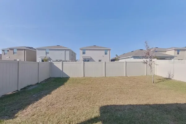 a view of a white house with a yard