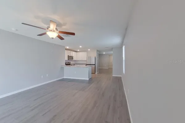 a view of a kitchen with a sink and wooden floor