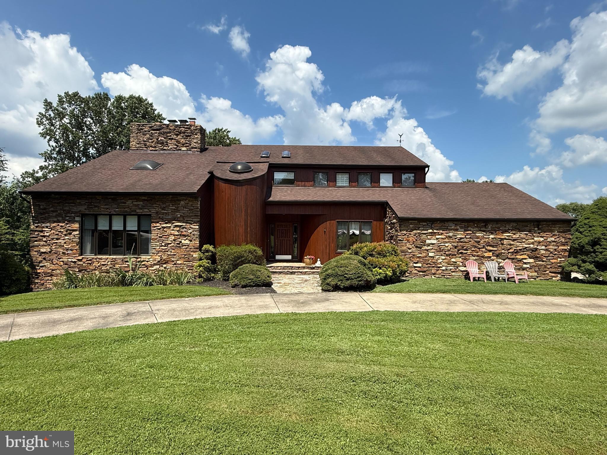 a front view of a house with a garden and yard