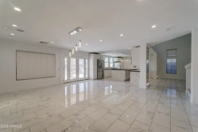 a view of a kitchen with a refrigerator and a sink