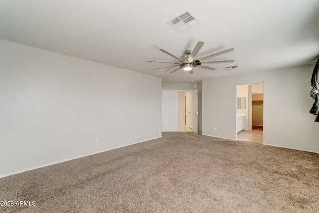 a view of a livingroom with a ceiling fan and window