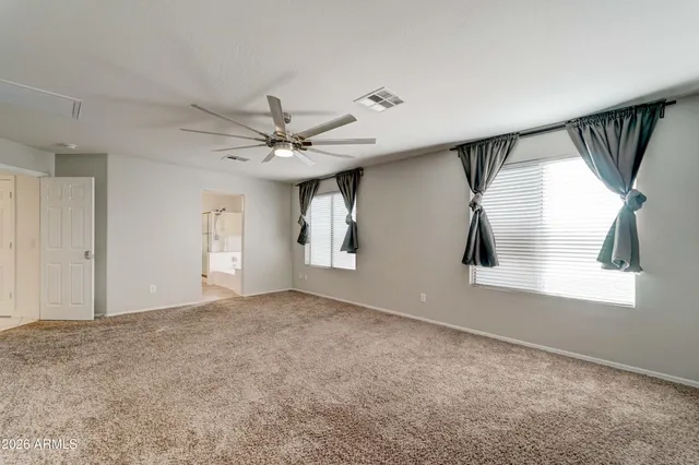 a spacious bathroom with a tub a sink and mirror