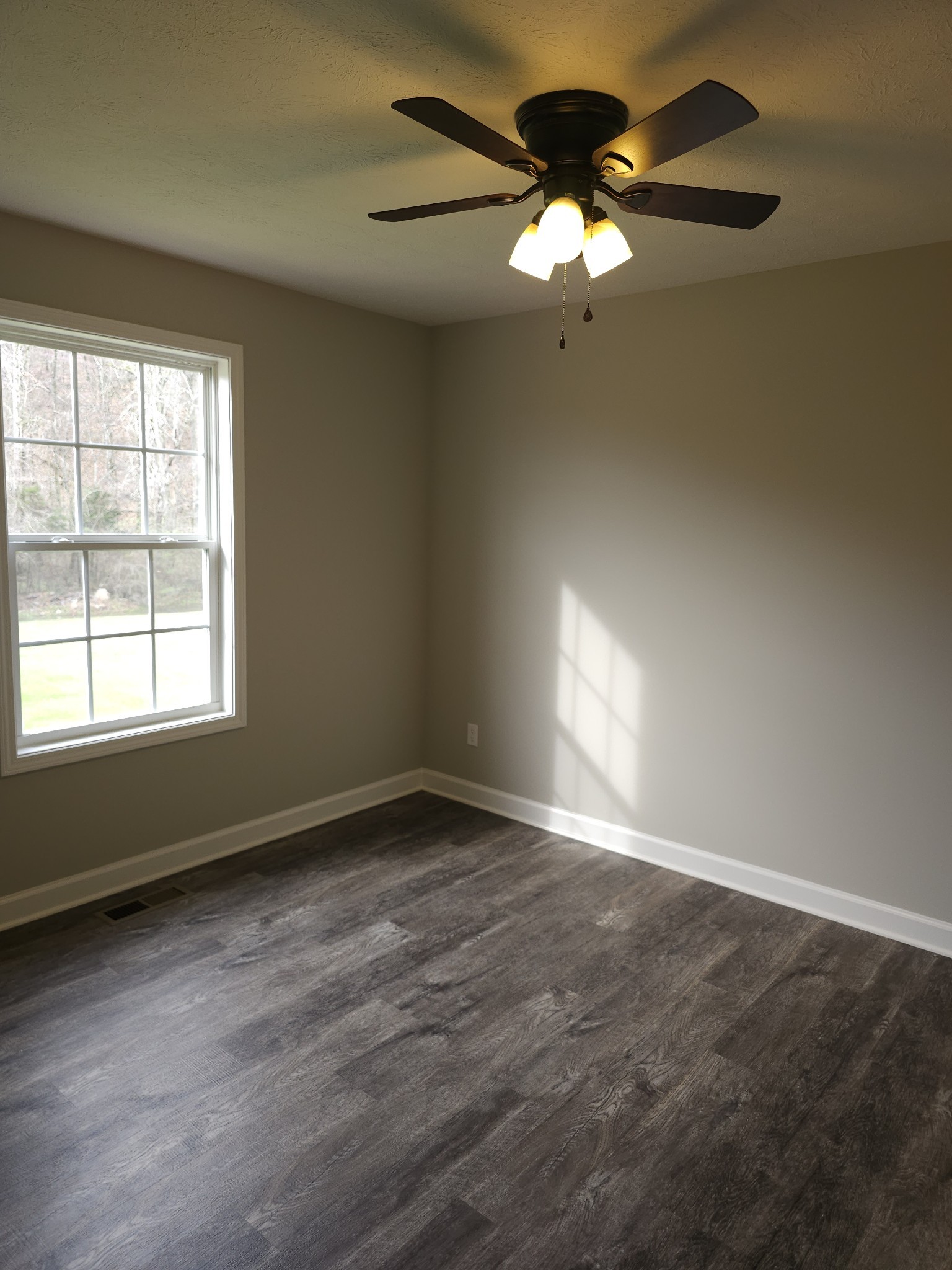4020 Hartsville Road Lafayette, TN 37083 - Photo 15 of 19 an empty room with a window and a fan