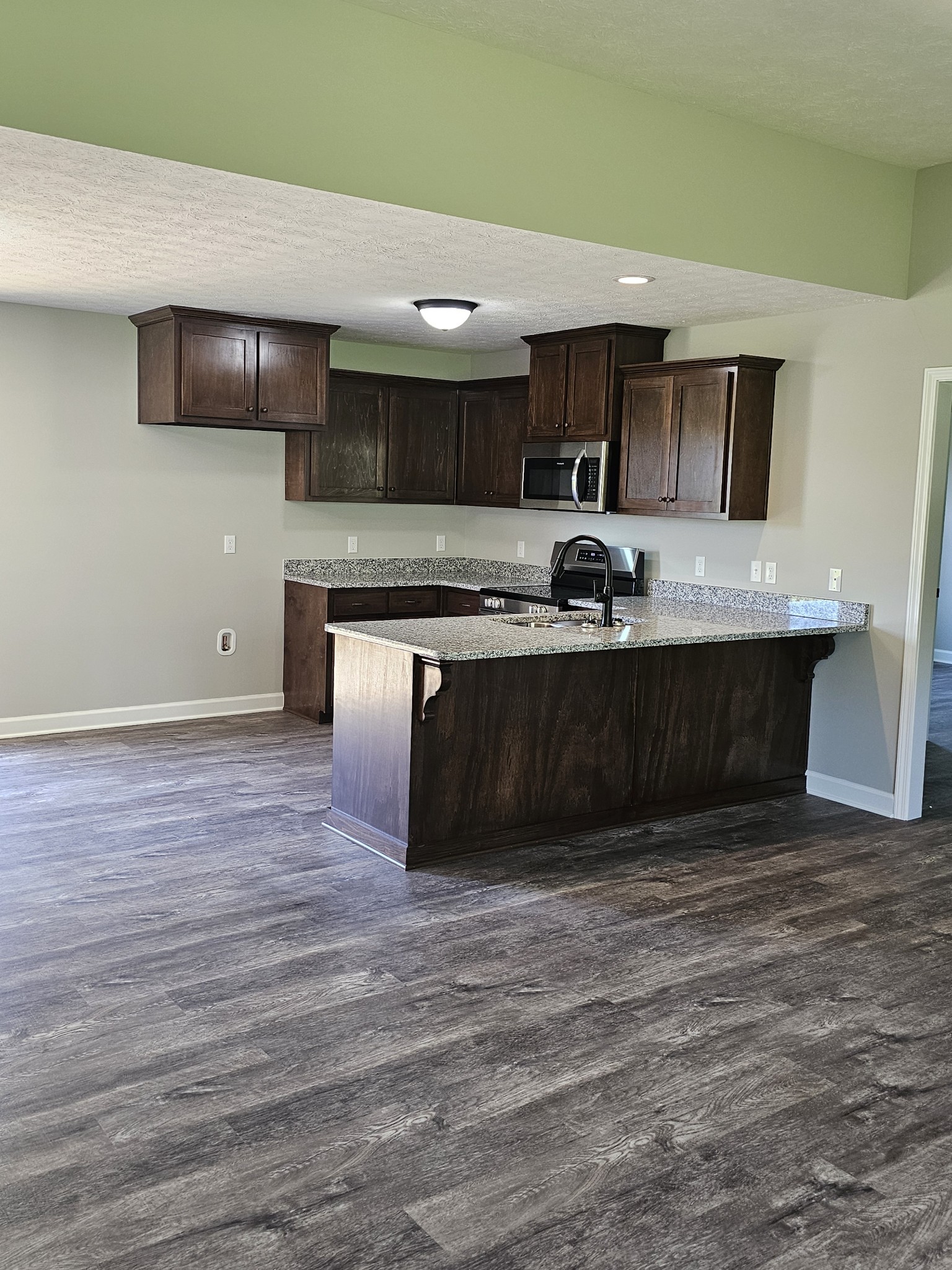 4020 Hartsville Road Lafayette, TN 37083 - Photo 2 of 19 a kitchen with stainless steel appliances granite countertop a sink and a stove