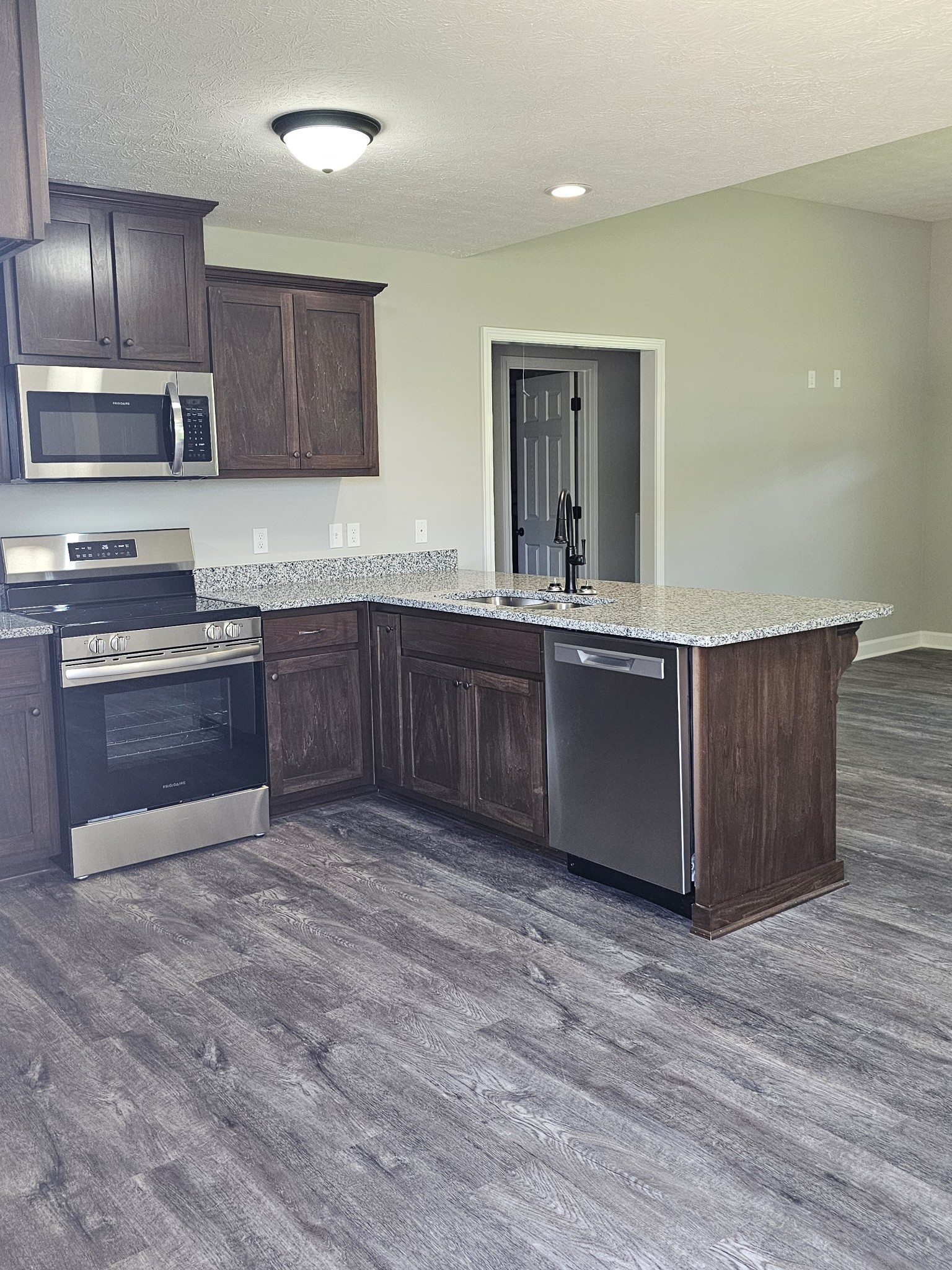 4020 Hartsville Road Lafayette, TN 37083 - Photo 3 of 19 a large kitchen with wooden cabinets and dishwasher