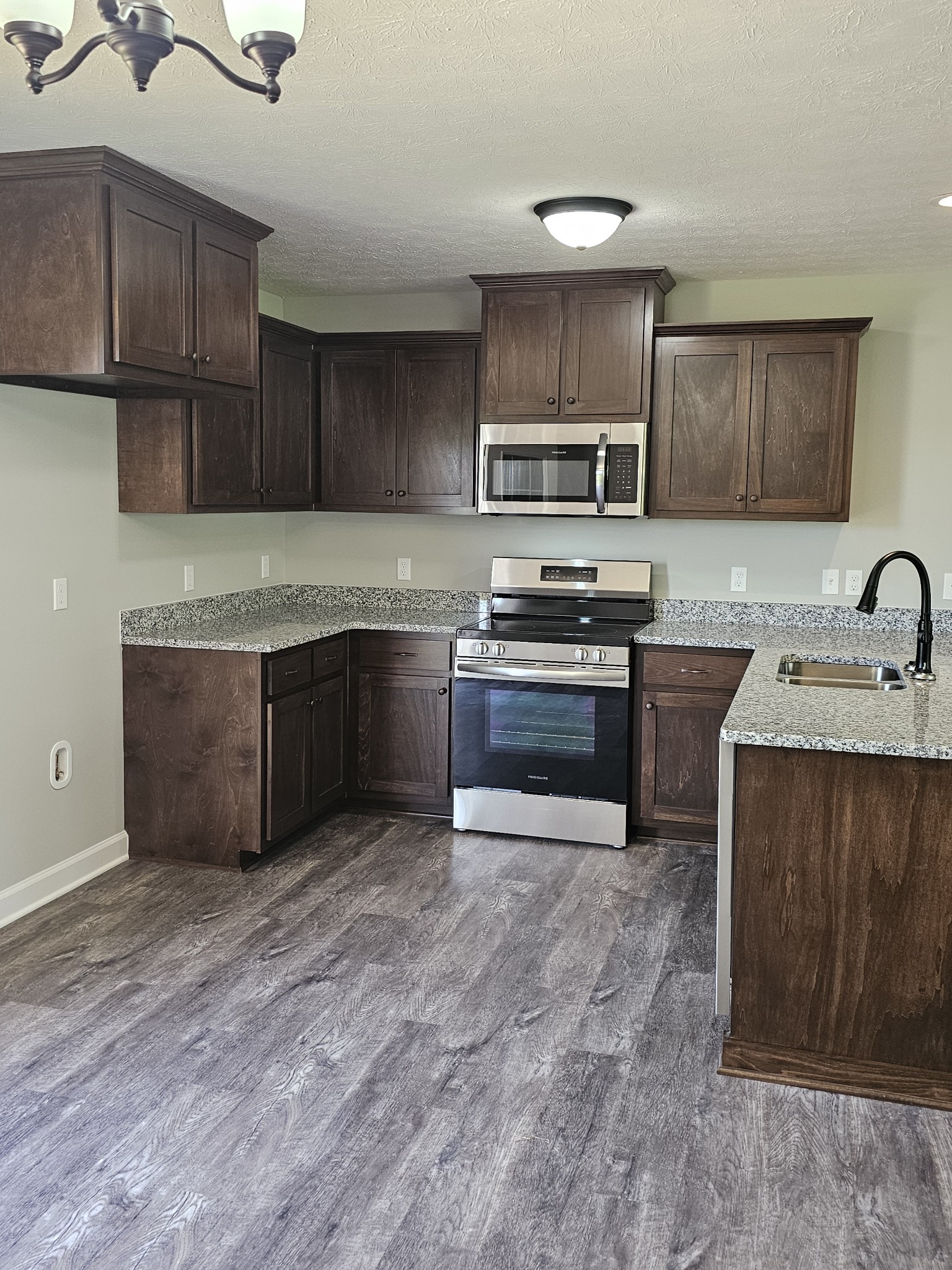 4020 Hartsville Road Lafayette, TN 37083 - Photo 4 of 19 a kitchen with stainless steel appliances granite countertop a sink stove and cabinets