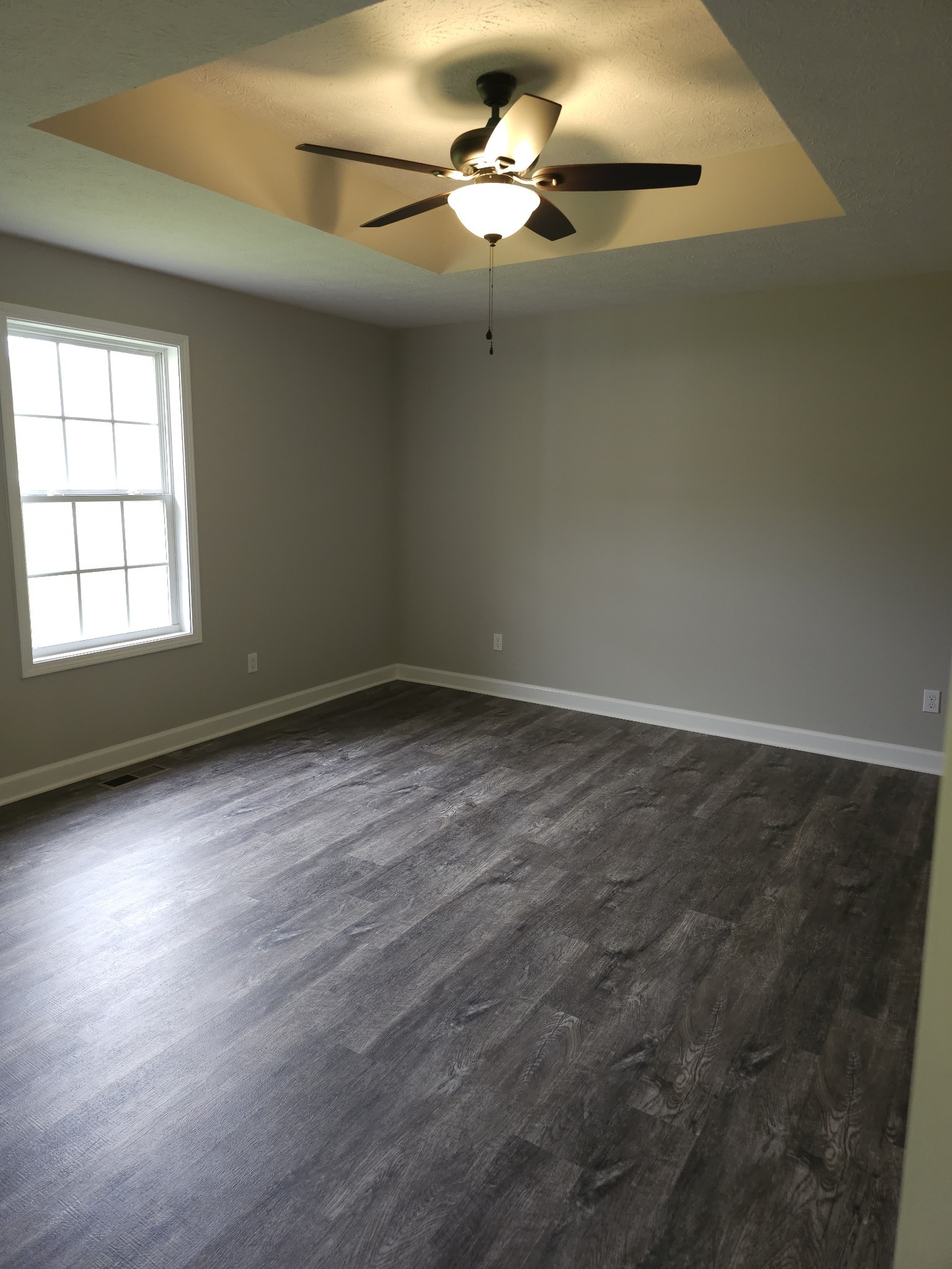 4020 Hartsville Road Lafayette, TN 37083 - Photo 6 of 19 an empty room with wooden floor fan and windows