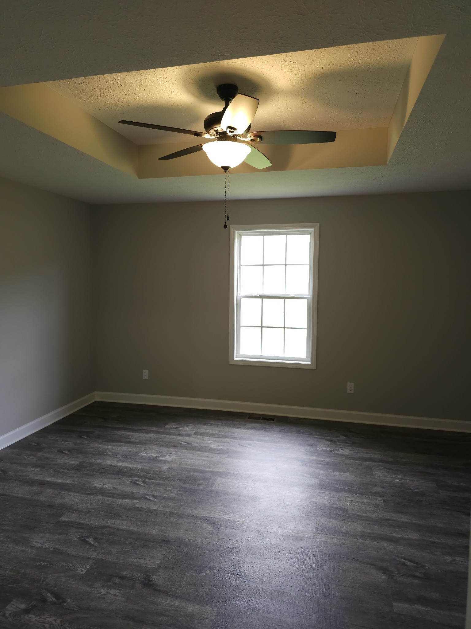4020 Hartsville Road Lafayette, TN 37083 - Photo 7 of 19 a view of an empty room with wooden floor and a window