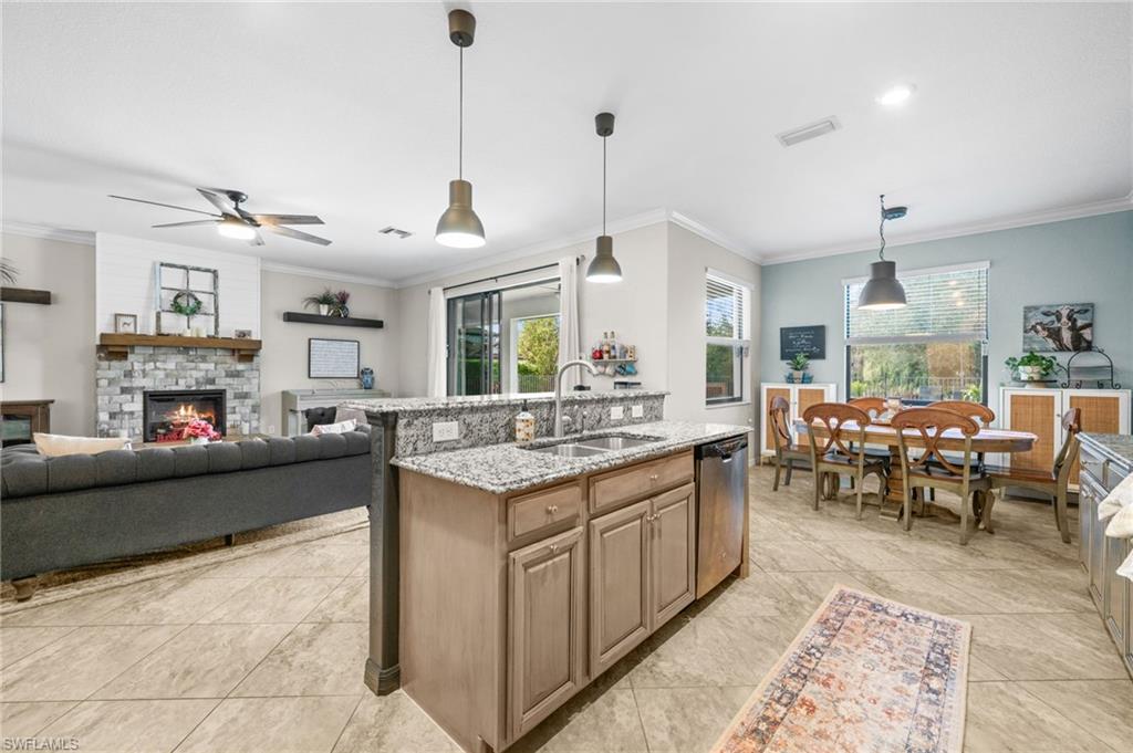 4754 Abaca Circle Naples, FL 34119 - Photo 9 of 46 a kitchen with sink stove and cabinets