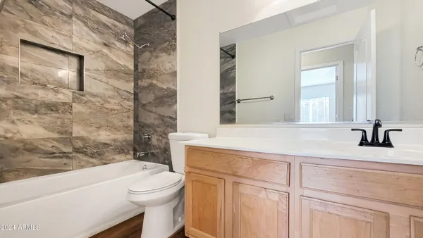 a white toilet sitting next to a bathroom sink