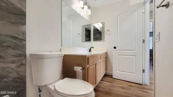 a view of an empty room with a window and a ceiling fan