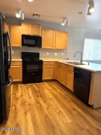 a large kitchen with a stove a sink and a refrigerator