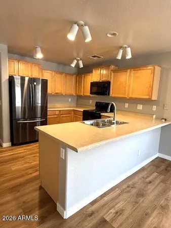 a kitchen with stainless steel appliances a refrigerator and a stove