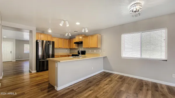 a kitchen with stainless steel appliances a refrigerator sink and stove