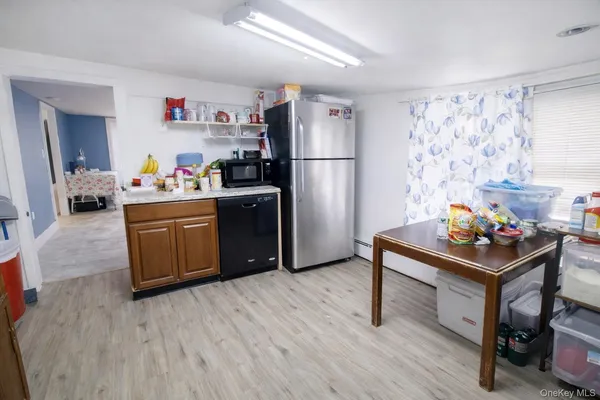 a kitchen with stainless steel appliances a stove refrigerator and a refrigerator
