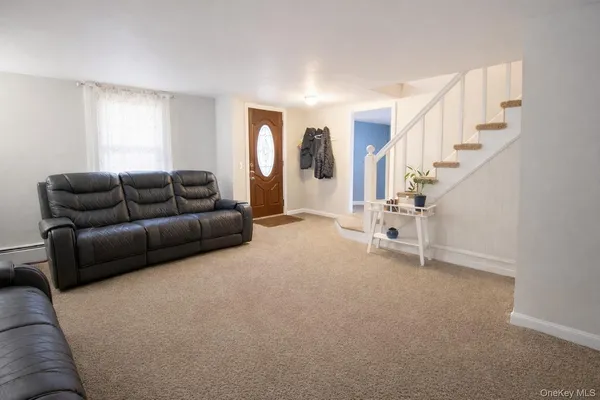 a living room with furniture and stairs
