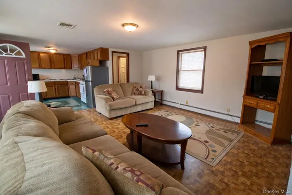 a living room with furniture a fireplace and a flat screen tv