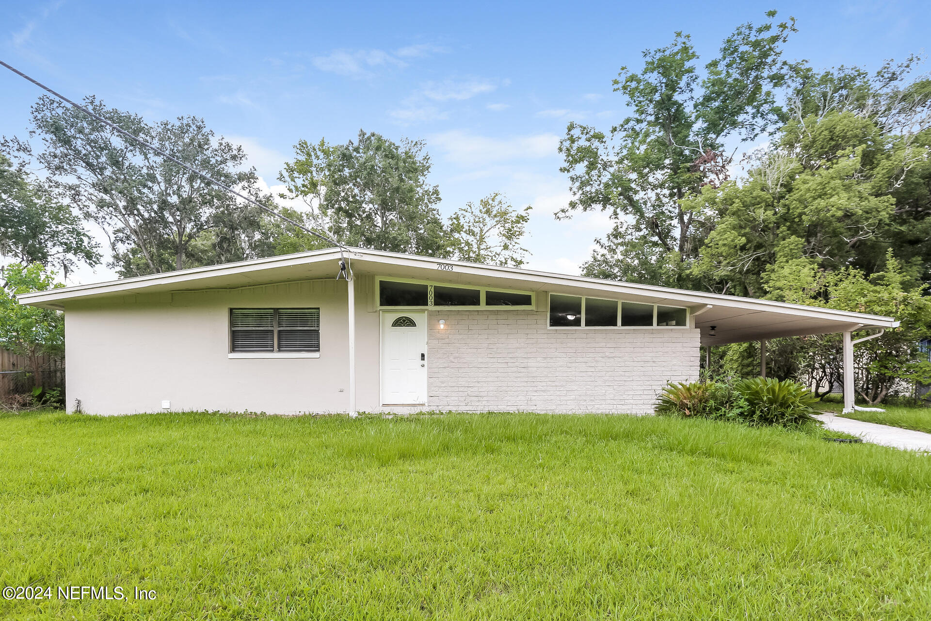 7003 Rollo Road Jacksonville, FL 32205 - Photo 1 of 21 a front view of a house with garden