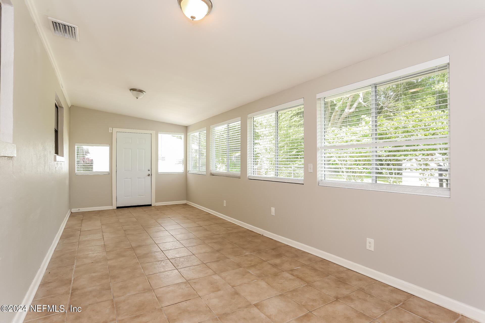 7003 Rollo Road Jacksonville, FL 32205 - Photo 11 of 21 a view of an empty room with a window