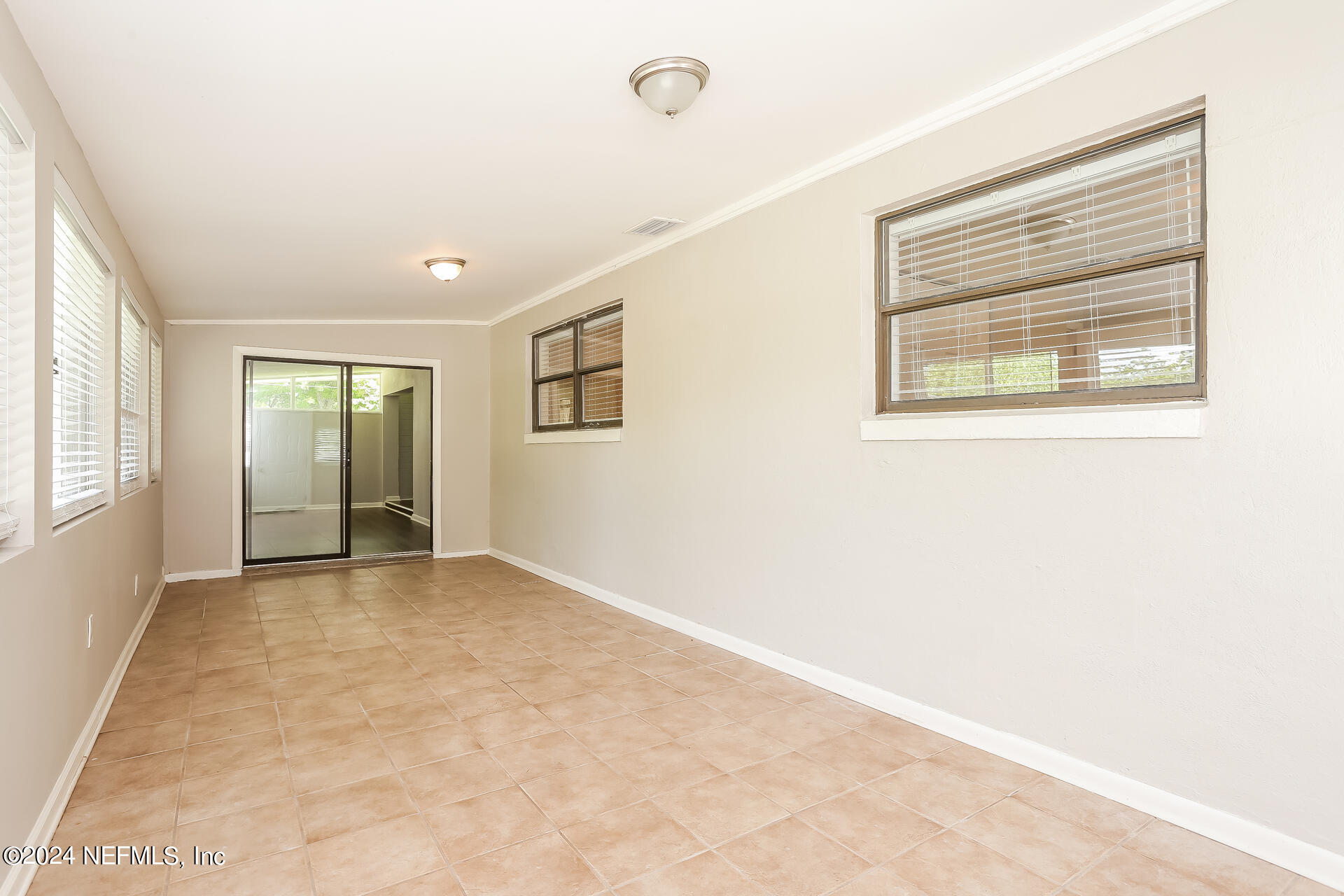 7003 Rollo Road Jacksonville, FL 32205 - Photo 12 of 21 an empty room with windows