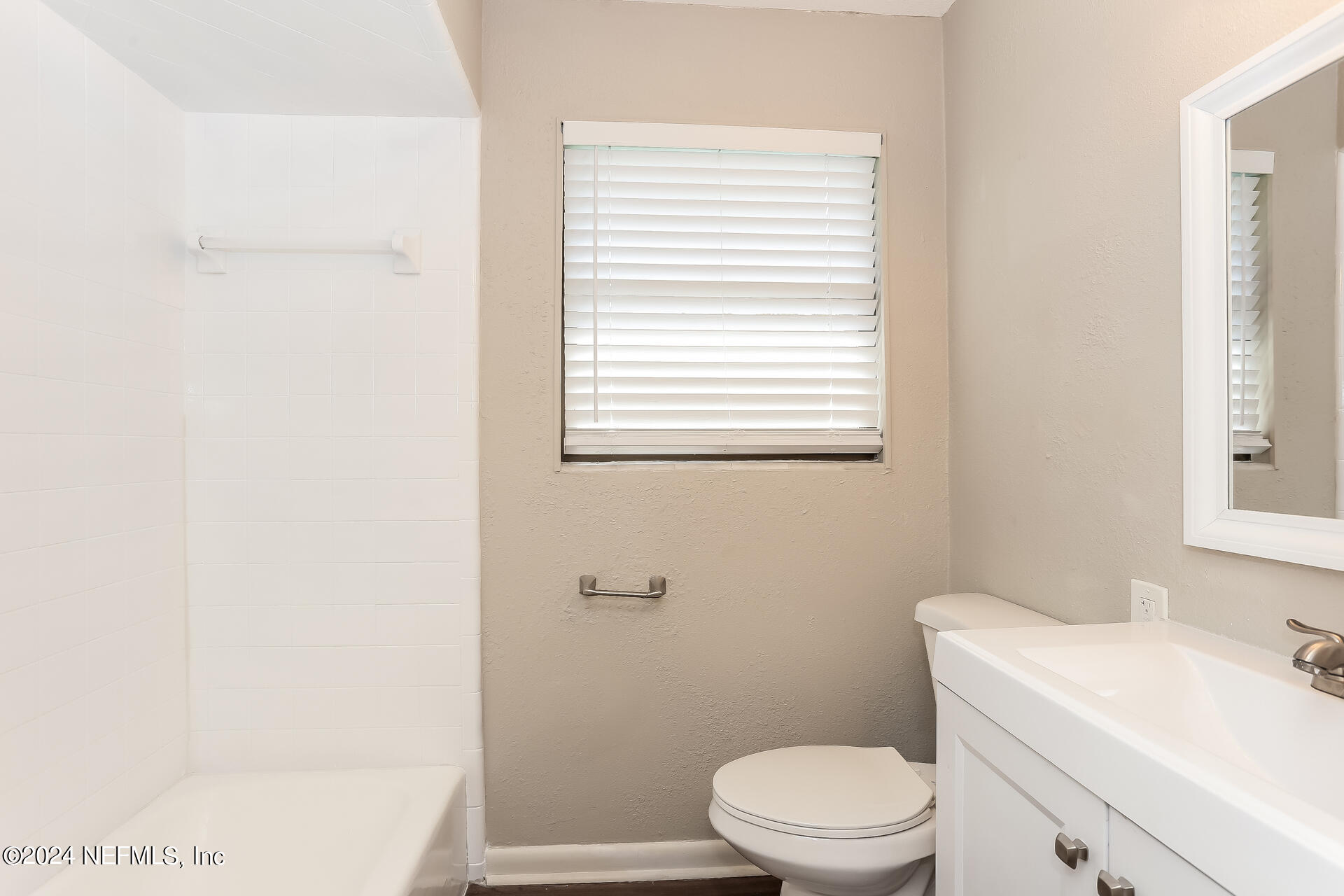 7003 Rollo Road Jacksonville, FL 32205 - Photo 15 of 21 a white toilet sitting next to a bathroom sink