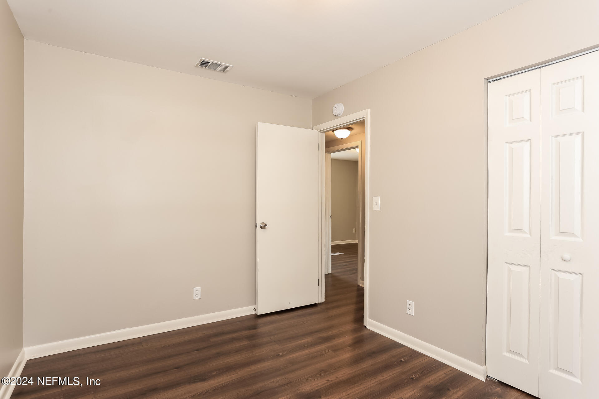 7003 Rollo Road Jacksonville, FL 32205 - Photo 17 of 21 a view of an empty room with wooden floor