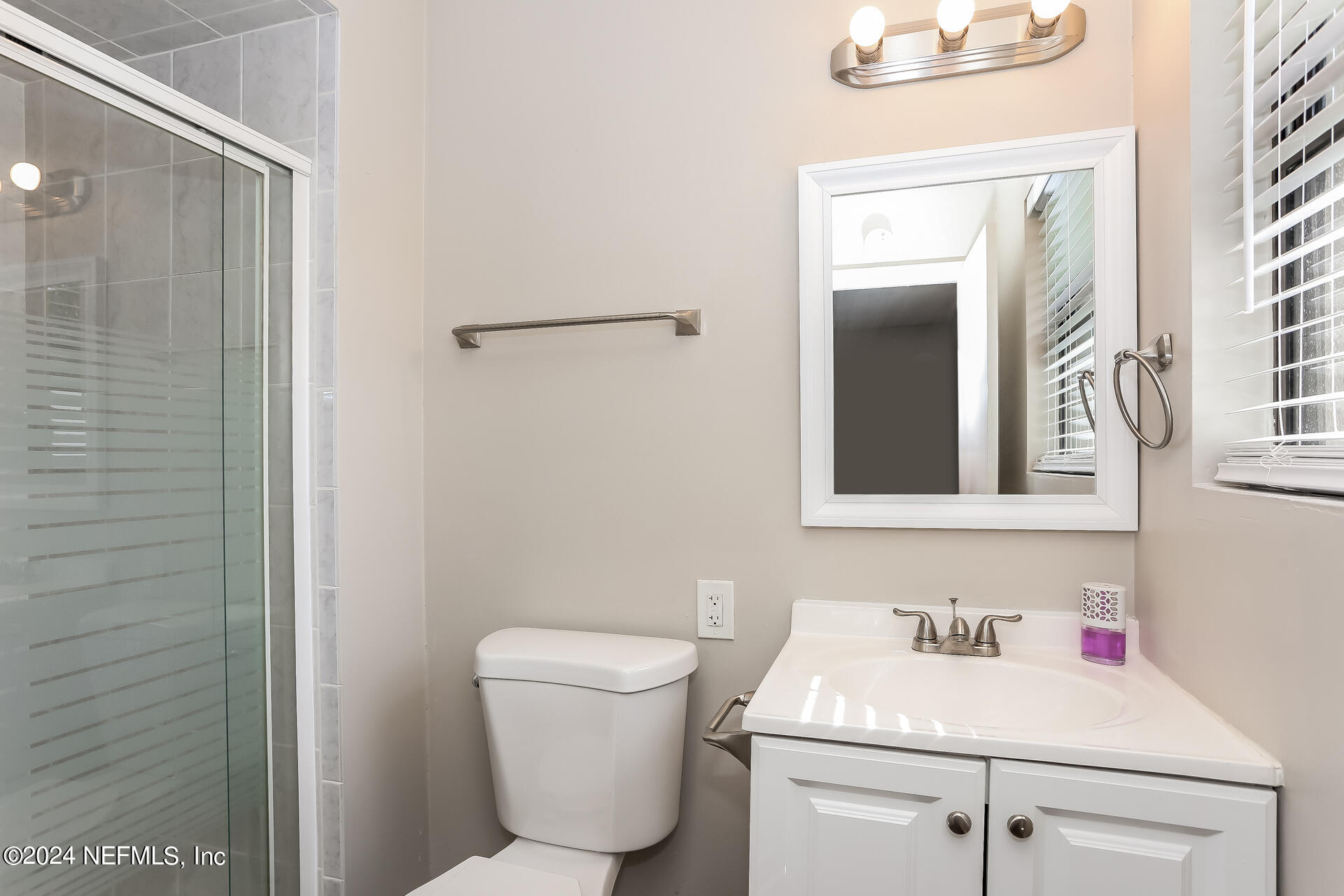 7003 Rollo Road Jacksonville, FL 32205 - Photo 18 of 21 a bathroom with a sink toilet and vanity