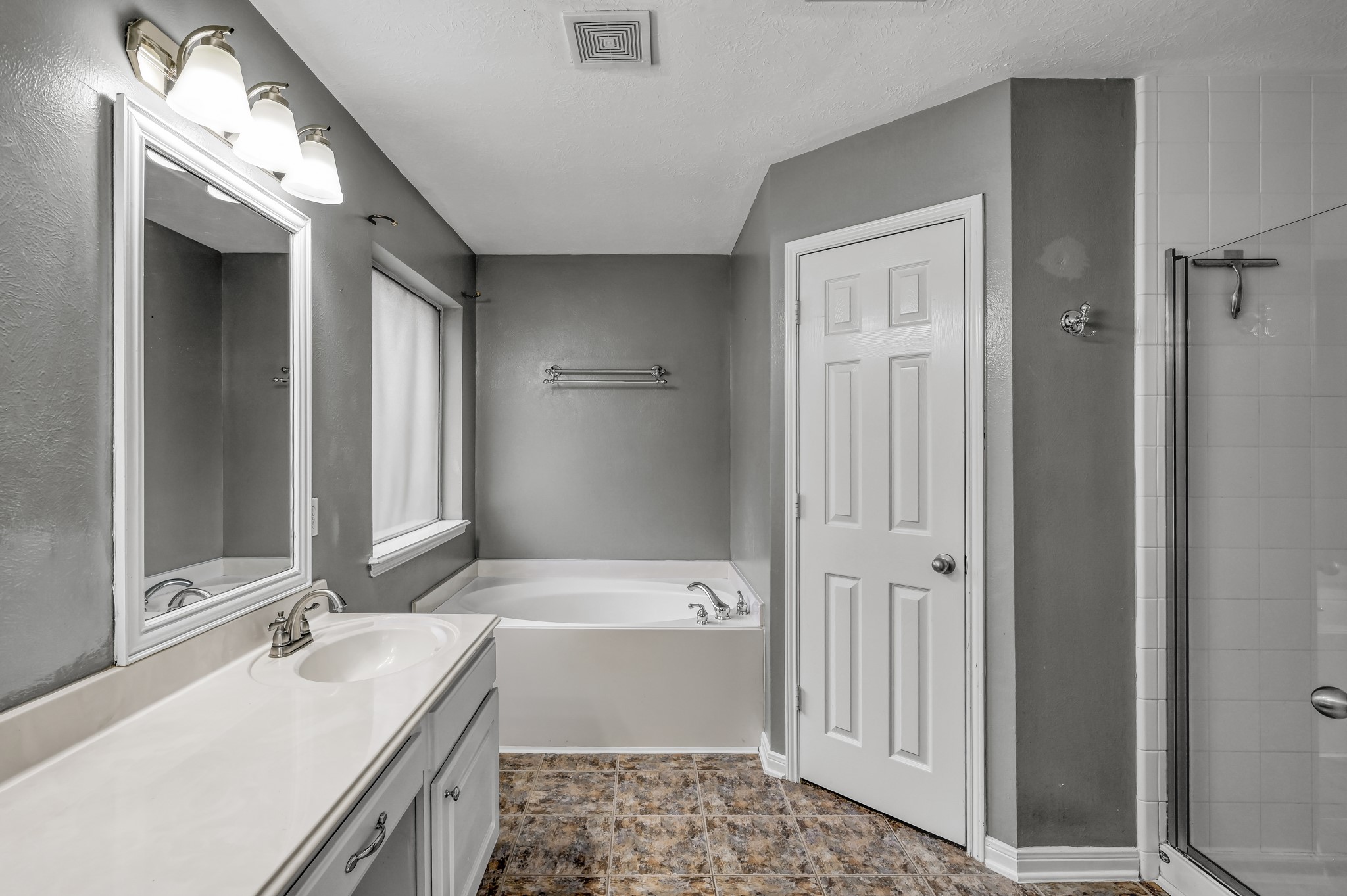 21331 Timber Pines Drive Spring, TX 77388 - Photo 14 of 22 Do you prefer bubbles or steam? The choice is yours with this oval garden tub and glass enclosed shower. And the primary closet features a custom ELFA shelving system for the ideal organization of all things!