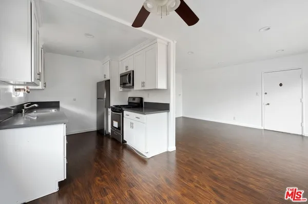 a kitchen with stainless steel appliances a stove a sink dishwasher and a refrigerator