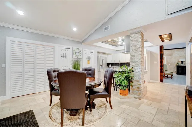a view of a dining room with furniture and a potted plant