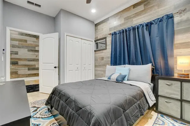 a bed sitting in a bedroom next to a window