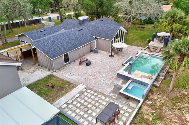 an aerial view of a house with garden space and sitting area