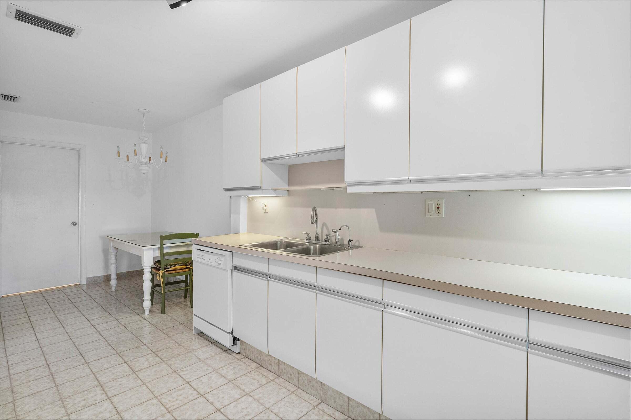 6711 North Ocean Boulevard, Unit 13 Ocean Ridge, FL 33435 - Photo 17 of 50 a kitchen with a sink and cabinets