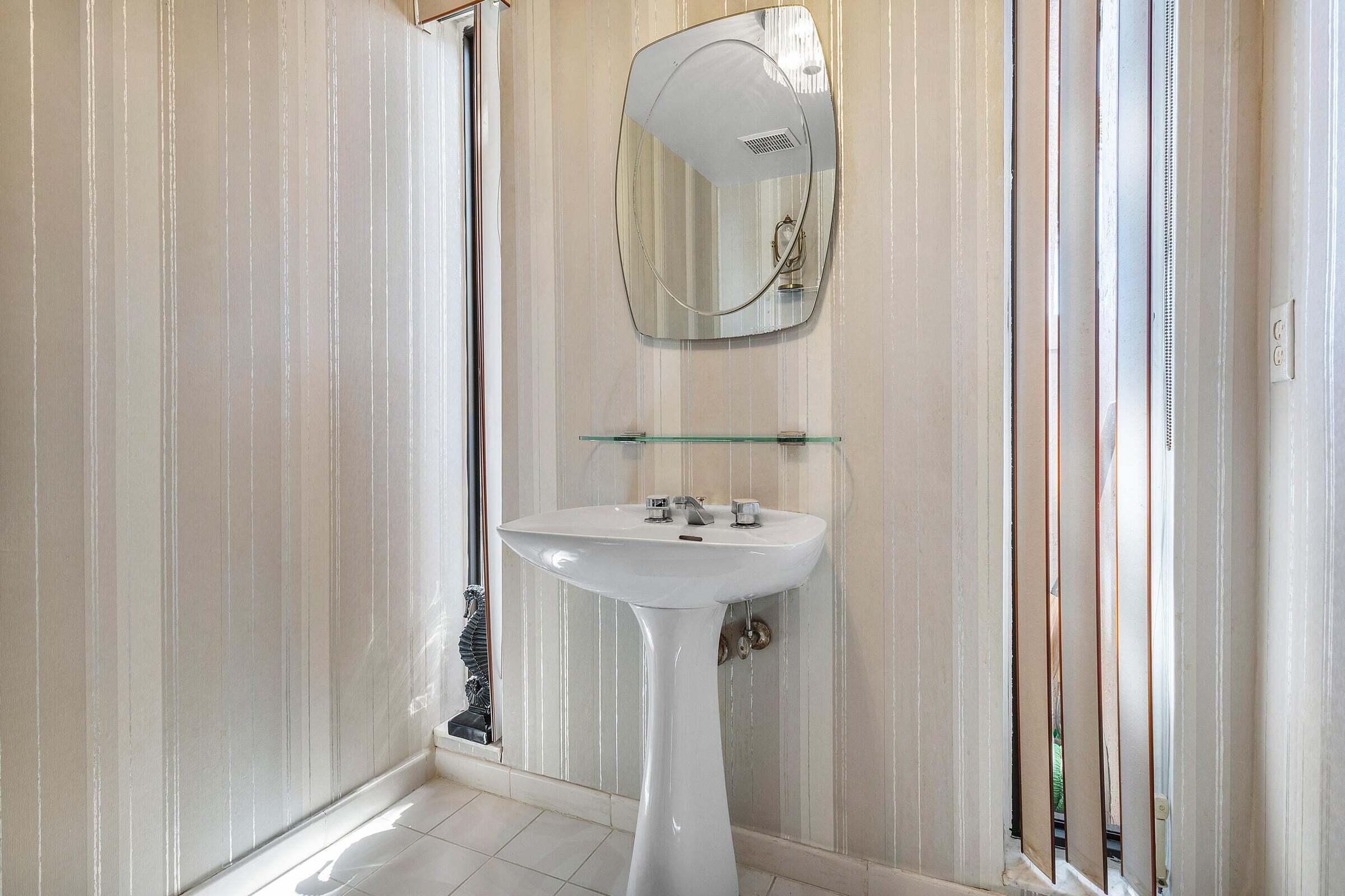 6711 North Ocean Boulevard, Unit 13 Ocean Ridge, FL 33435 - Photo 18 of 50 a bathroom with a sink and a mirror