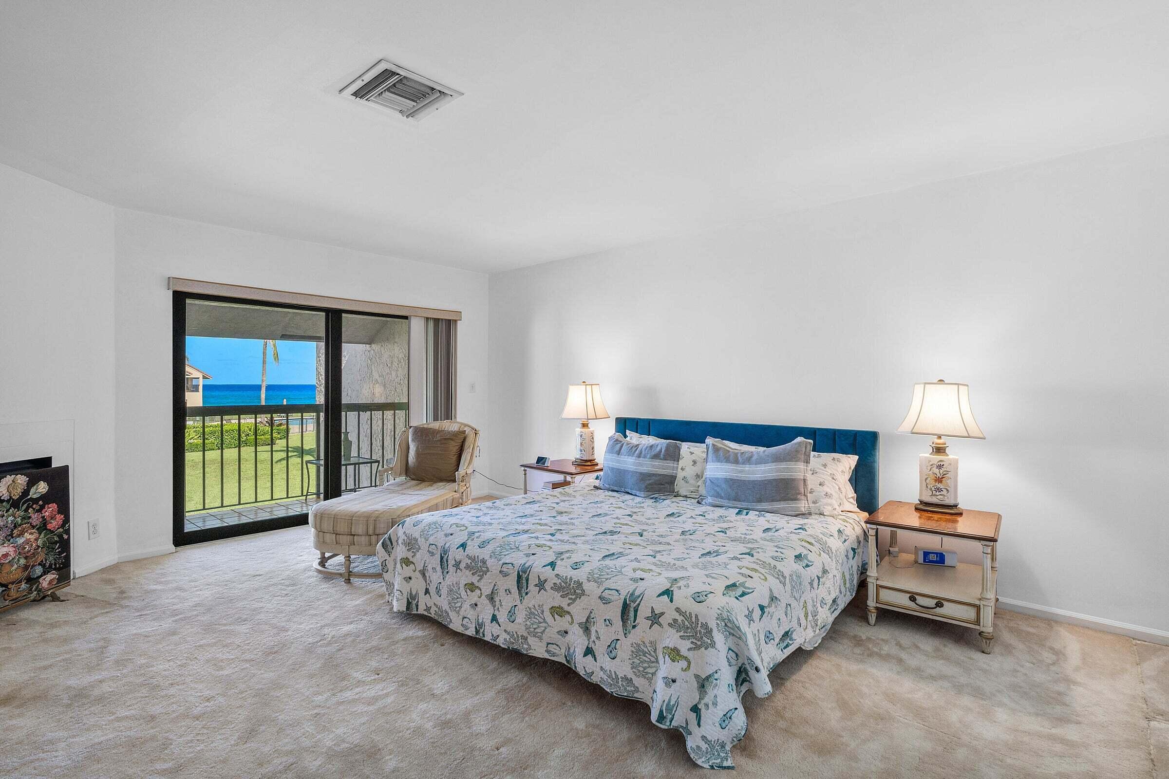 6711 North Ocean Boulevard, Unit 13 Ocean Ridge, FL 33435 - Photo 21 of 50 a bedroom with a bed and a lamp next to a window
