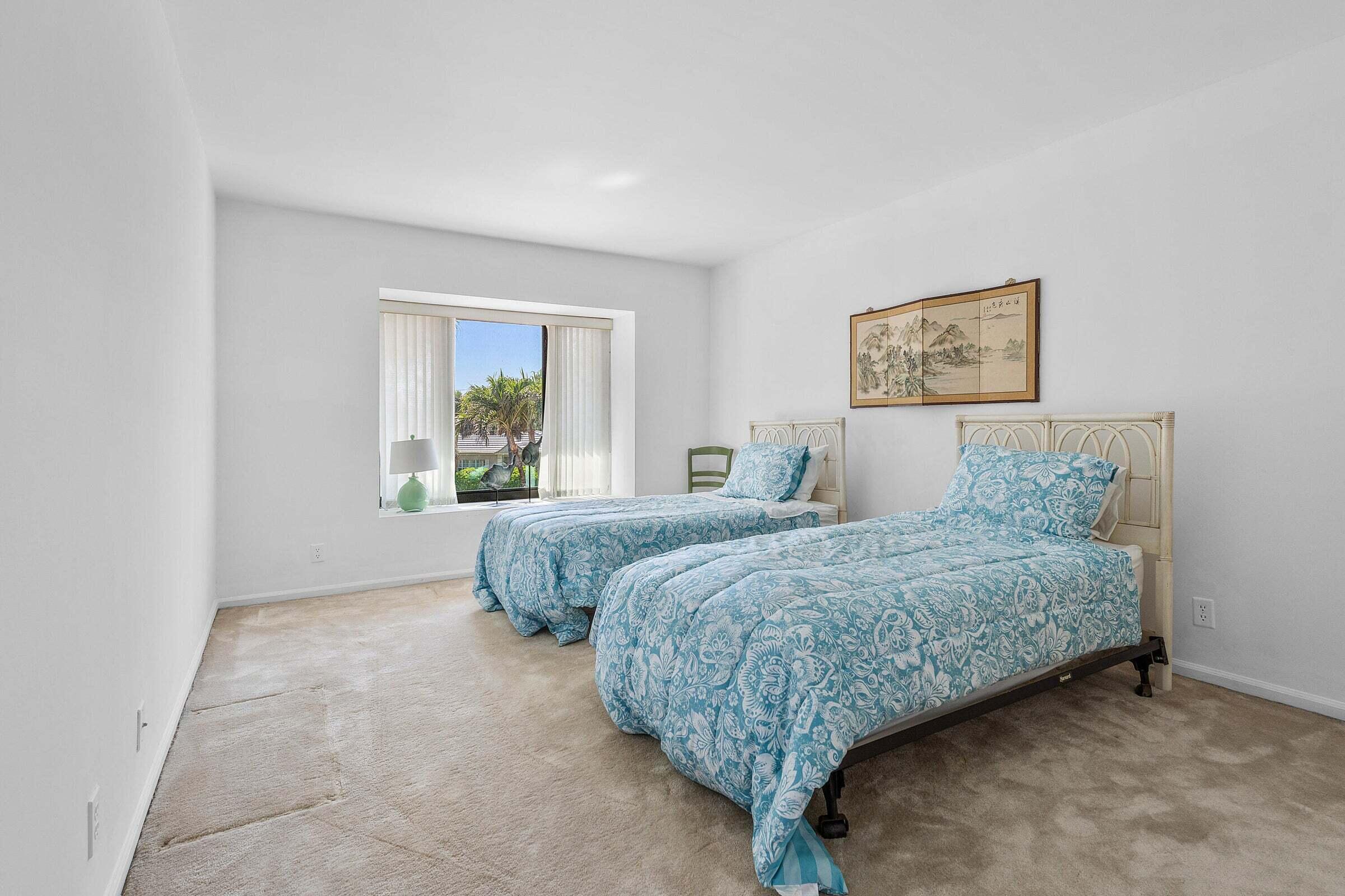 6711 North Ocean Boulevard, Unit 13 Ocean Ridge, FL 33435 - Photo 27 of 50 a bedroom with a bed and a window