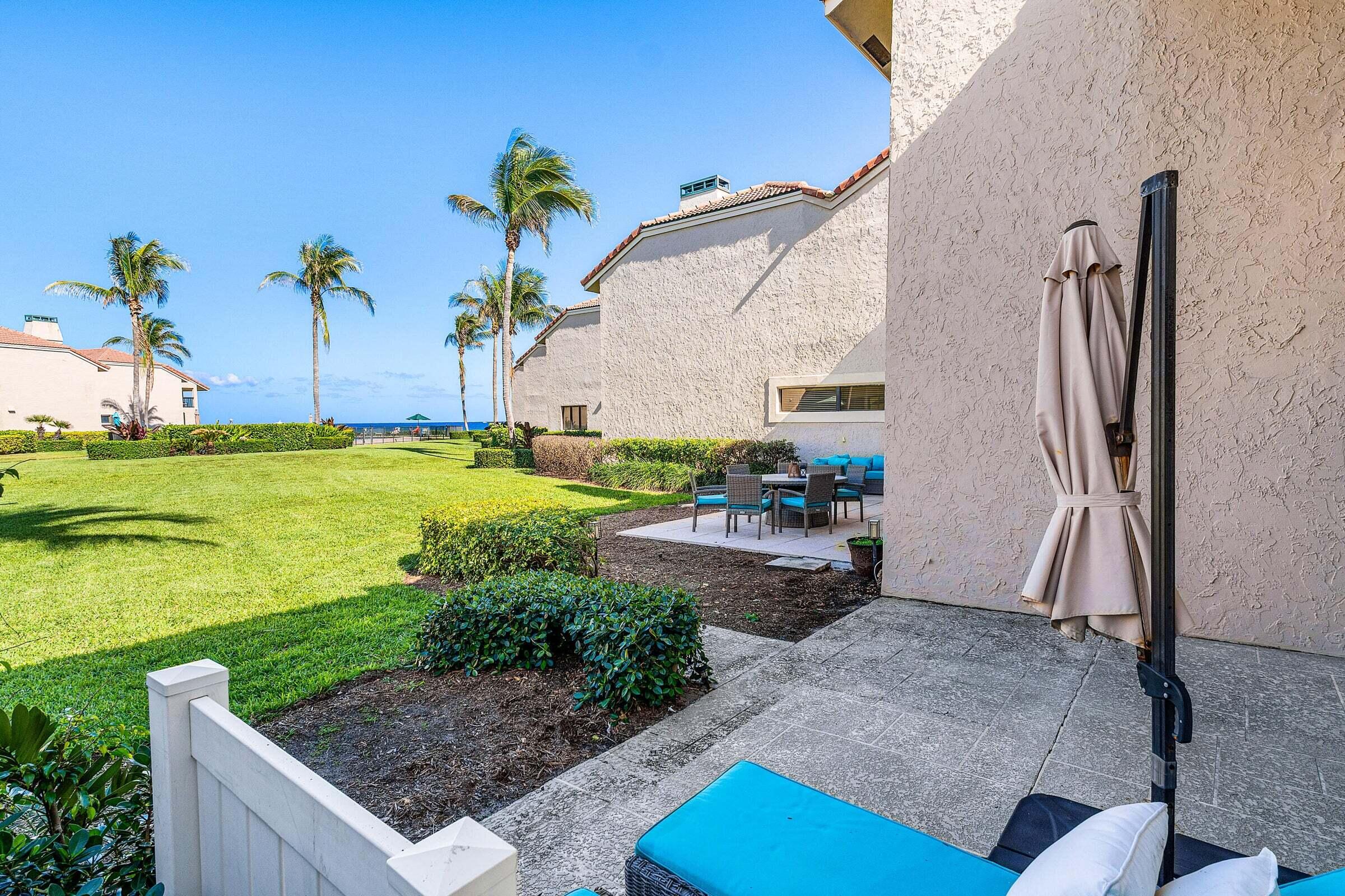 6711 North Ocean Boulevard, Unit 13 Ocean Ridge, FL 33435 - Photo 33 of 50 a view of a backyard with plants and outdoor seating