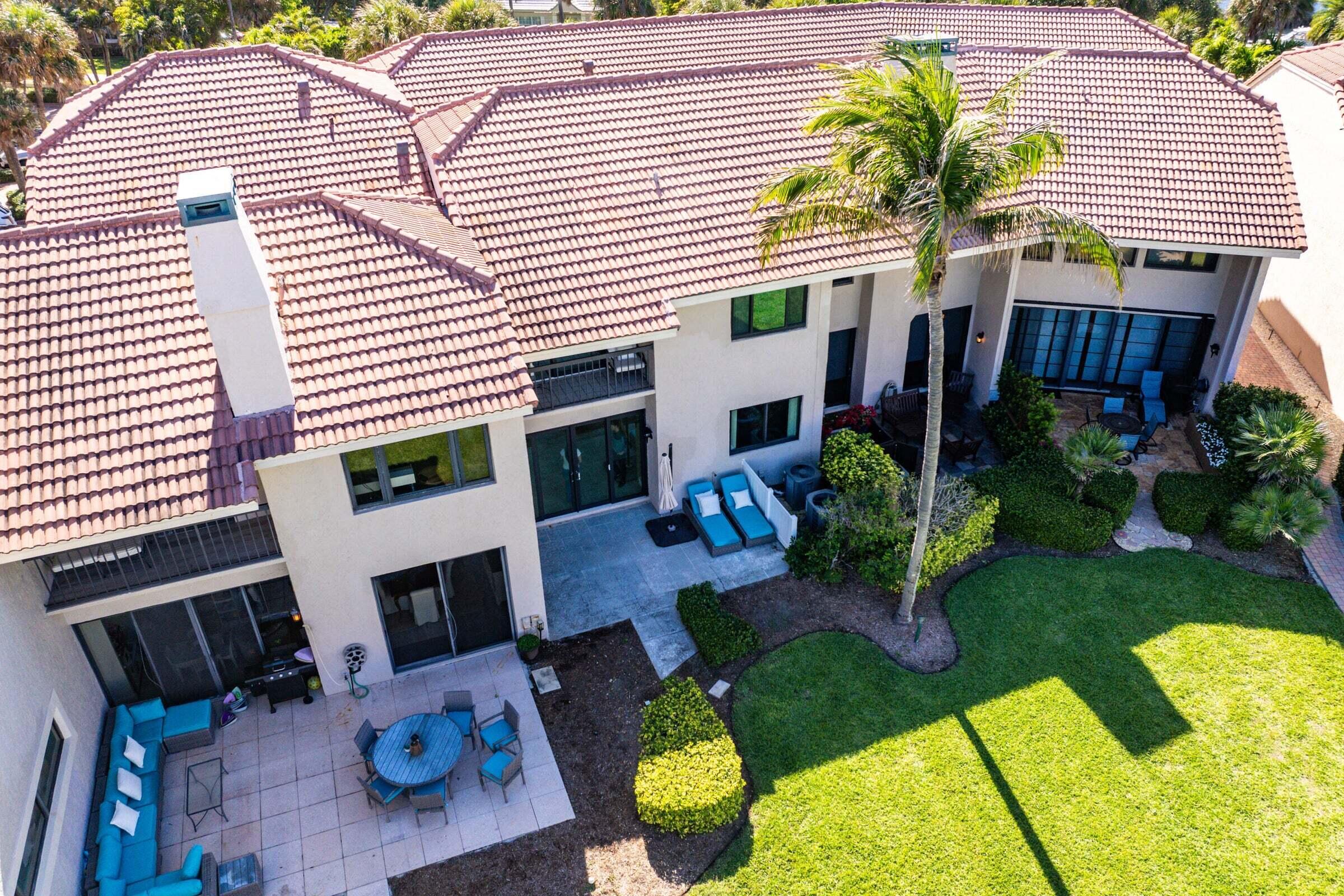 6711 North Ocean Boulevard, Unit 13 Ocean Ridge, FL 33435 - Photo 36 of 50 a view of a chairs and table in backyard of the house