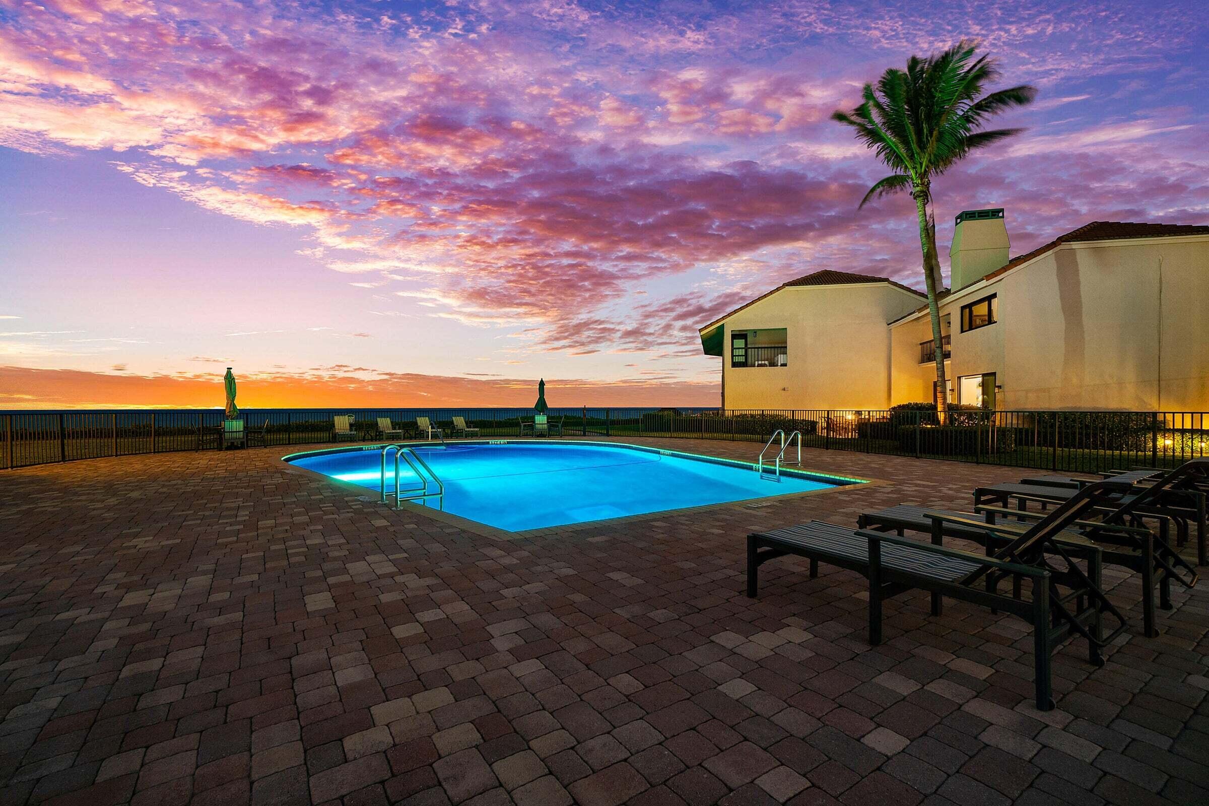 6711 North Ocean Boulevard, Unit 13 Ocean Ridge, FL 33435 - Photo 42 of 50 a view of a swimming pool with a table and chairs