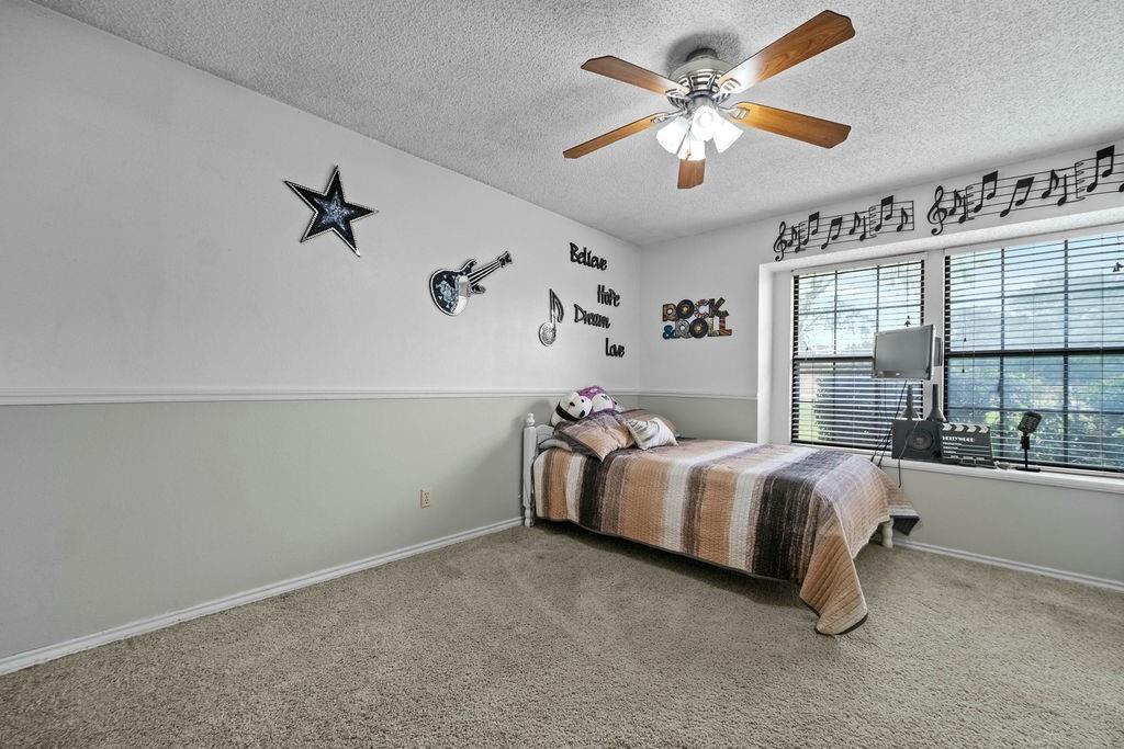 6939 Calender Road Arlington, TX 76001 - Photo 20 of 40 Bedroom featuring a textured ceiling, carpet, baseboards, and ceiling fan
