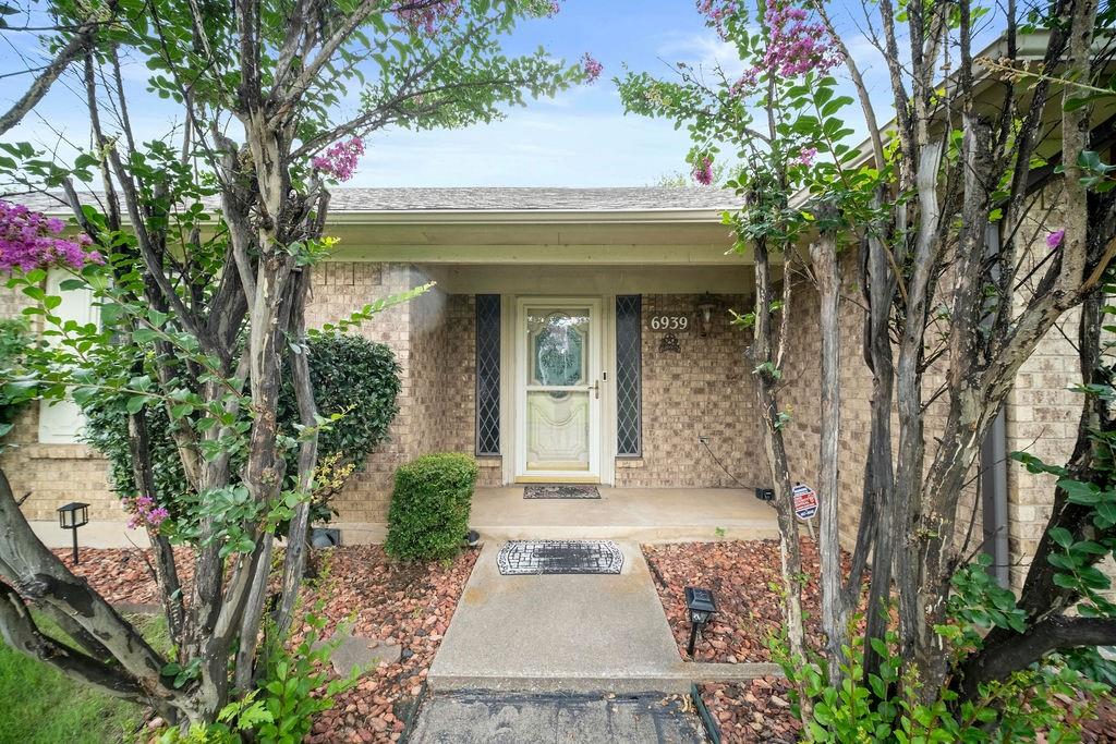 6939 Calender Road Arlington, TX 76001 - Photo 2 of 40 Entrance to property with brick siding and a shingled roof
