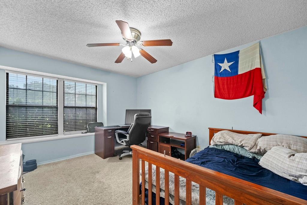6939 Calender Road Arlington, TX 76001 - Photo 28 of 40 Bedroom with a desk, carpet, a textured ceiling, a ceiling fan, and baseboards