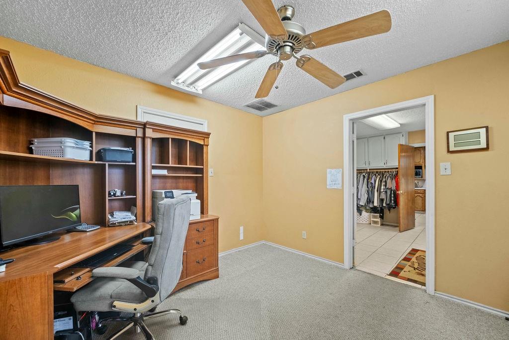 6939 Calender Road Arlington, TX 76001 - Photo 31 of 40 Home office with a ceiling fan, a textured ceiling, light carpet, and baseboards