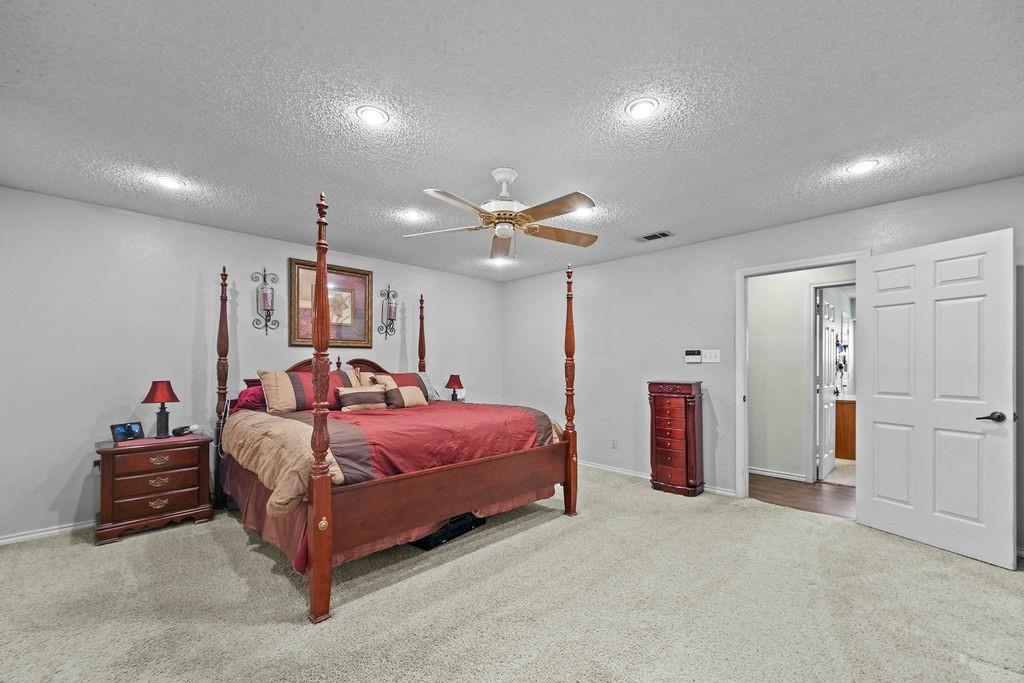 6939 Calender Road Arlington, TX 76001 - Photo 32 of 40 Bedroom with a textured ceiling, carpet floors, ceiling fan, baseboards, and recessed lighting