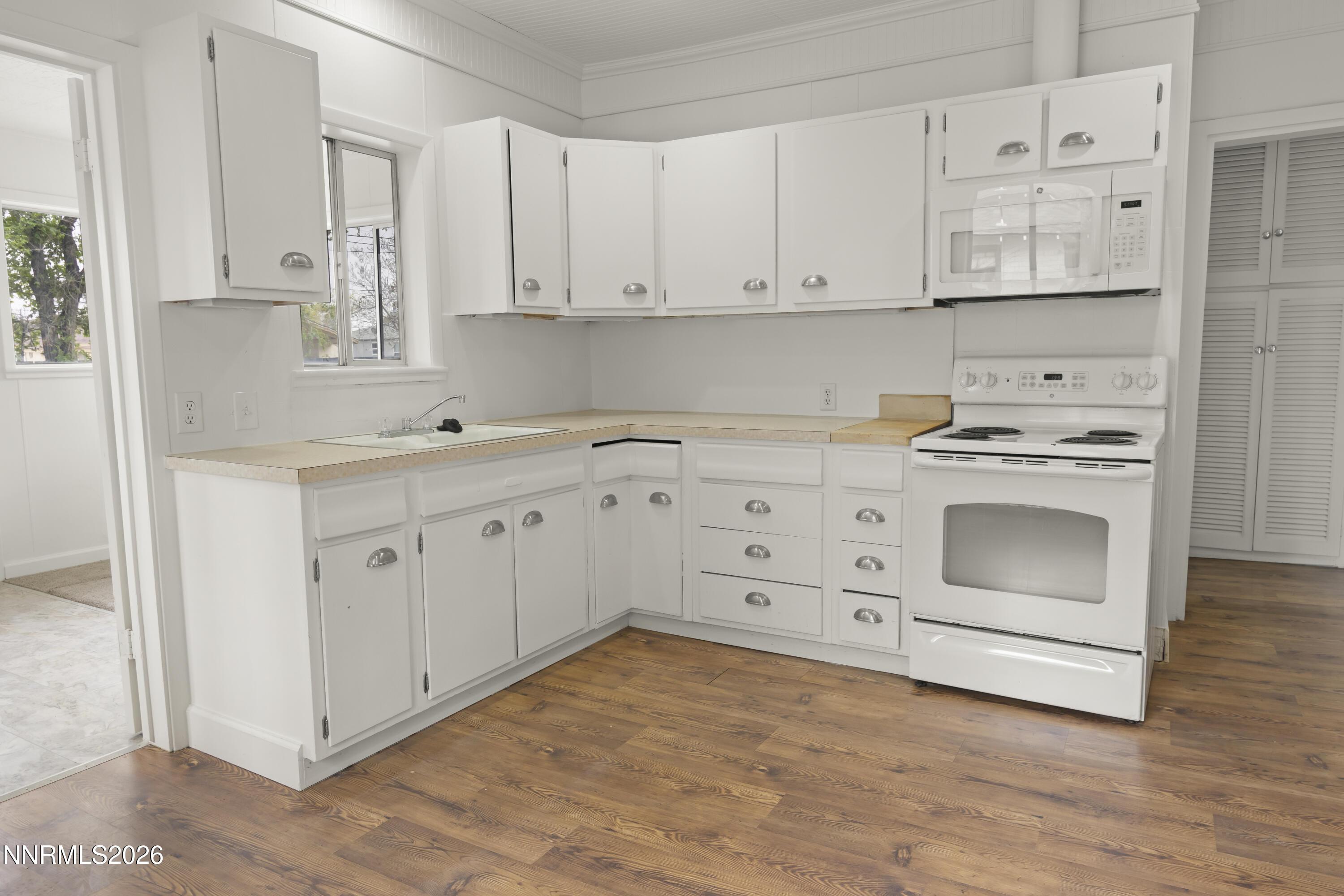 511 Churchill Street Fallon, NV 89406 - Photo 29 of 37 a kitchen with white cabinets and white appliances