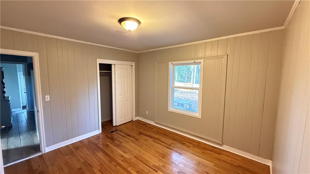 43 Bell Street Hartwell, GA 30643 - Photo 12 of 15 an empty room with wooden floor and windows