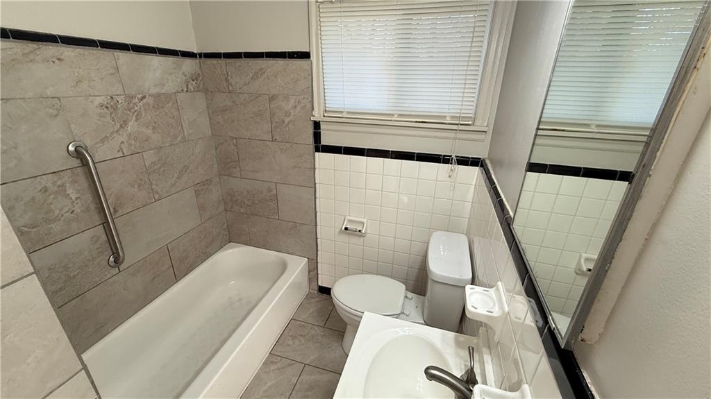 43 Bell Street Hartwell, GA 30643 - Photo 14 of 15 a bathroom with a tub shower and toilet