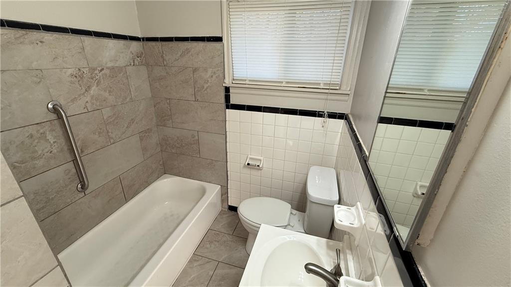 43 Bell Street Hartwell, GA 30643 - Photo 15 of 15 a bathroom with a tub shower and toilet