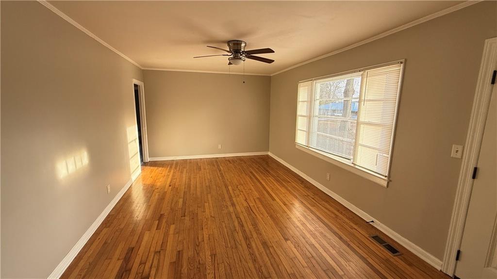 43 Bell Street Hartwell, GA 30643 - Photo 4 of 15 wooden floor in an empty room with a window