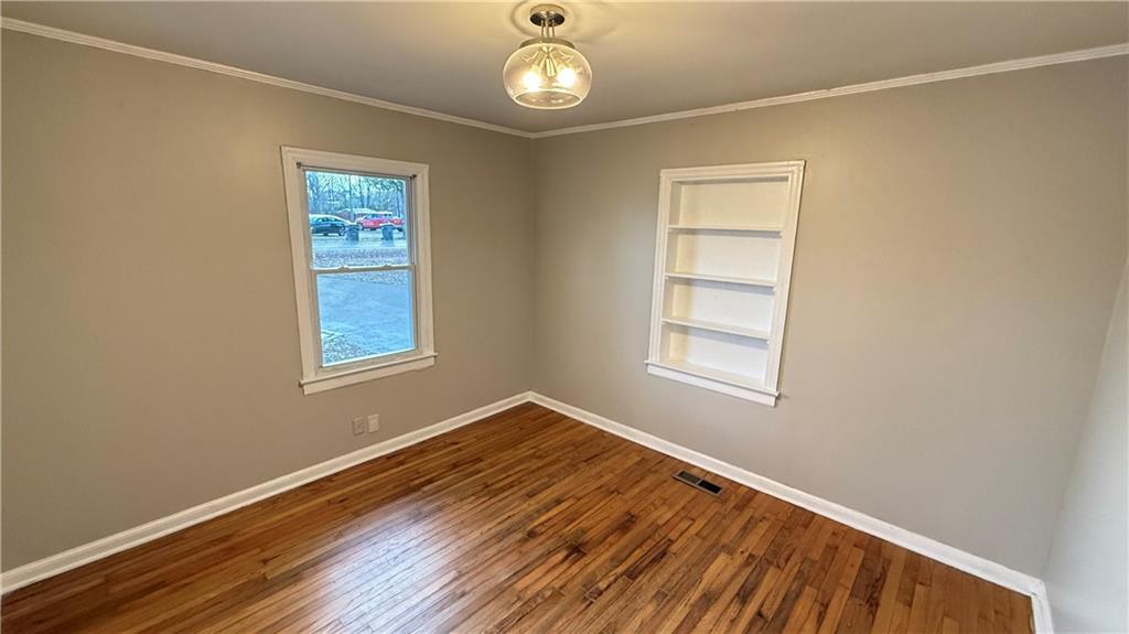 43 Bell Street Hartwell, GA 30643 - Photo 6 of 15 a view of an empty room with a window and wooden floor
